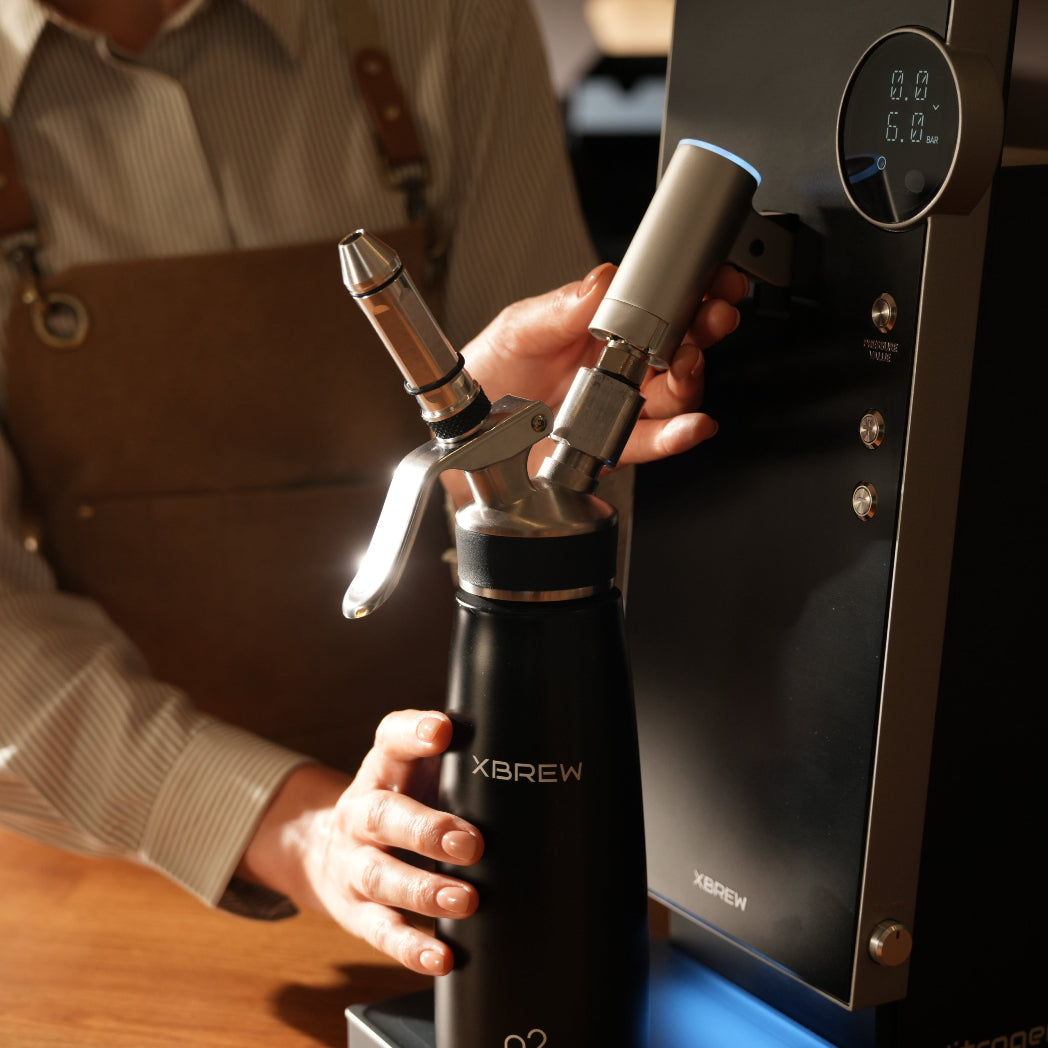 Person using a XBERW cream dispenser wearing an apron.
