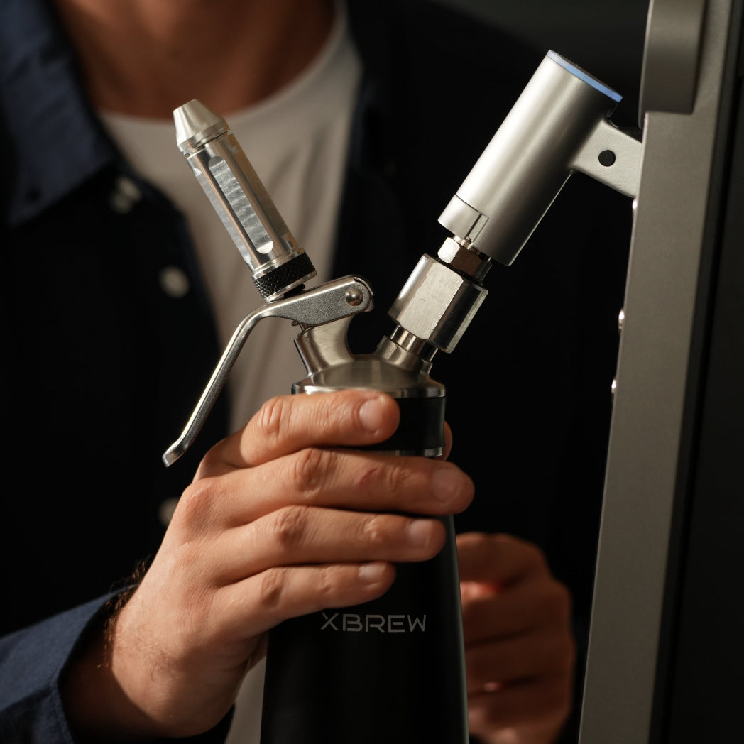 Person holding a X Brew nitro machine 
